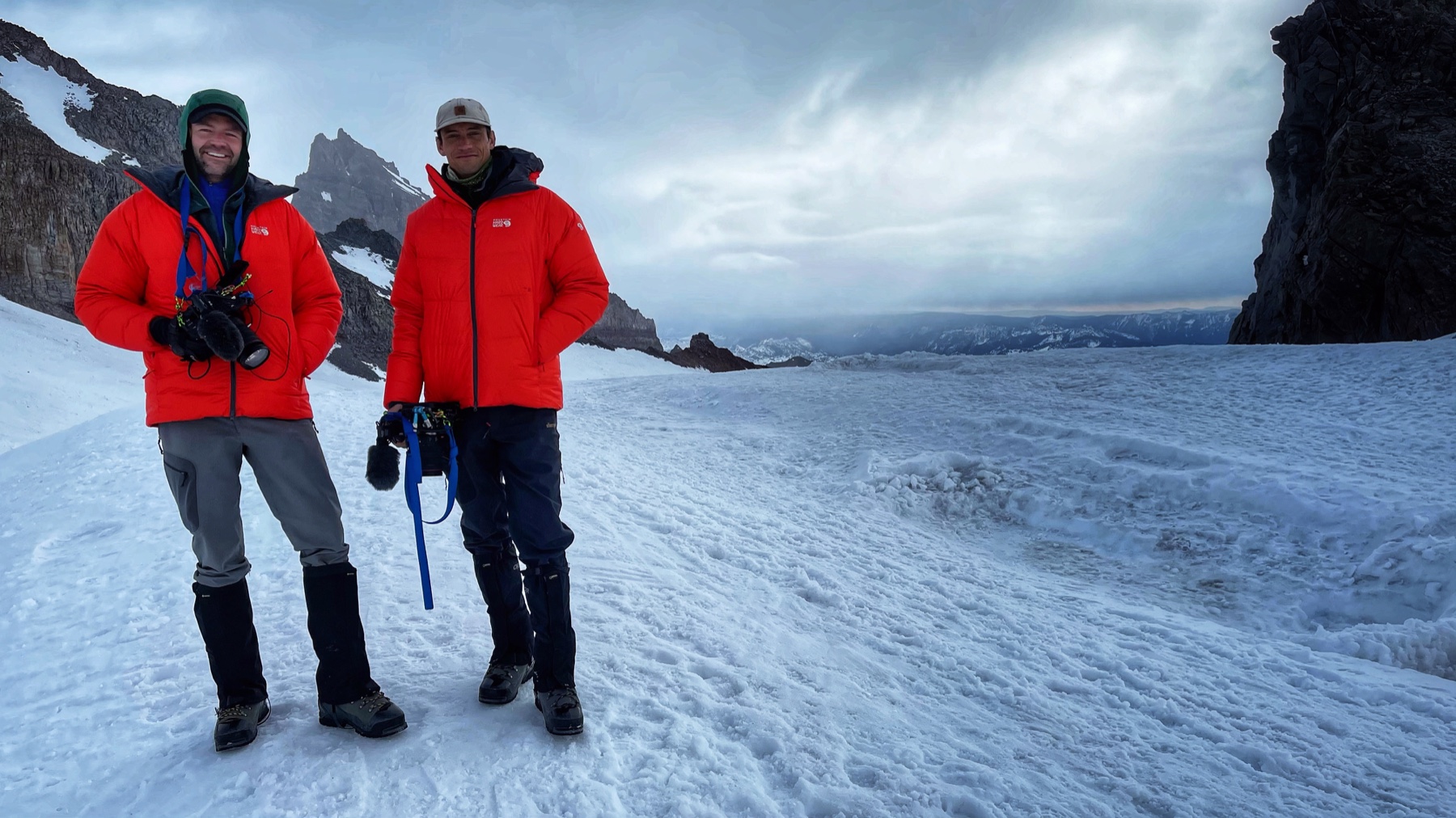 Two production crew members on a broad snowfield