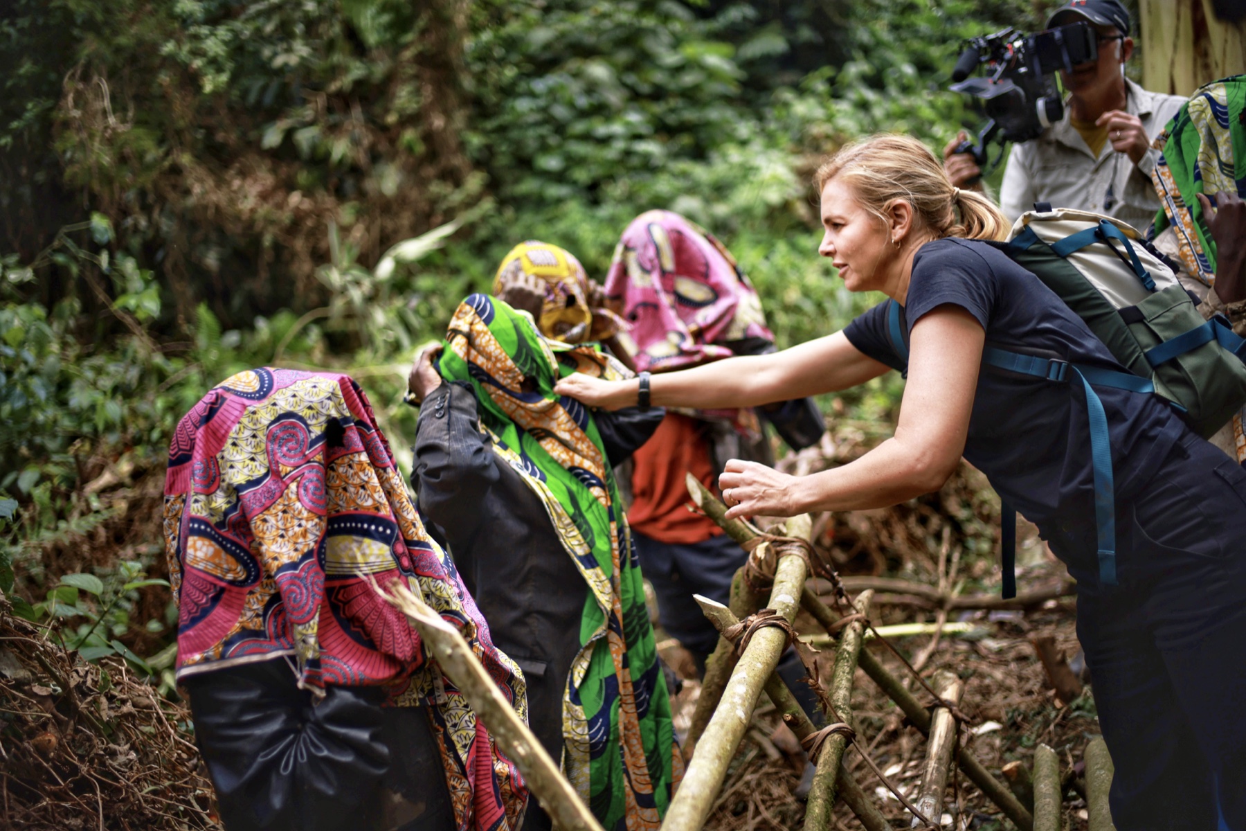 Mariana van Zeller and a camera crew climbing a jungle trail